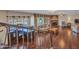 Sunlit living room boasts hardwood floors, a stone fireplace, and a bay window with custom valances at 19506 N 73Rd Ave, Glendale, AZ 85308