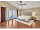 Main bedroom with wood floors, ceiling fan, and access to the backyard at 19506 N 73Rd Ave, Glendale, AZ 85308
