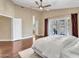 Bright main bedroom features hardwood floors, fan and french doors that lead to a balcony at 19506 N 73Rd Ave, Glendale, AZ 85308