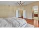 Bright bedroom features hardwood floors, fan and ensuite bathroom at 19506 N 73Rd Ave, Glendale, AZ 85308