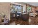 Comfortable office space with a large window, hardwood flooring, and views of the backyard at 19506 N 73Rd Ave, Glendale, AZ 85308