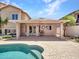 Covered patio with a ceiling fan, providing a cool and shaded retreat by the pool at 19506 N 73Rd Ave, Glendale, AZ 85308