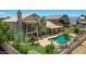 Aerial view of backyard featuring a pool, hot tub, patio, balcony, and palm trees at 19506 N 73Rd Ave, Glendale, AZ 85308