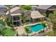 Aerial view of backyard featuring a pool, hot tub, patio, balcony, and palm trees at 19506 N 73Rd Ave, Glendale, AZ 85308