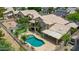 Aerial view of backyard featuring a pool, hot tub, patio, balcony, and palm trees at 19506 N 73Rd Ave, Glendale, AZ 85308