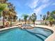 Beautiful pool with rock accents, spa, and lush landscaping, perfect for outdoor enjoyment and relaxation at 19506 N 73Rd Ave, Glendale, AZ 85308