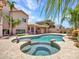 Private backyard featuring a pool and spa, complete with rock accents and mature landscaping at 19506 N 73Rd Ave, Glendale, AZ 85308