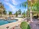 Backyard oasis featuring a stunning pool with a built-in spa and mature landscaping with view of the golf course at 19506 N 73Rd Ave, Glendale, AZ 85308