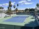 A well-maintained tennis court surrounded by lush greenery offering a great place for friendly matches at 19506 N 73Rd Ave, Glendale, AZ 85308
