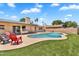 View of the backyard featuring a pool, lush green lawn, and covered outdoor seating area at 2025 E Magdalena Dr, Tempe, AZ 85283
