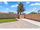 Landscaped backyard with well-maintained lawn and brick-paved patio with block wall at 2025 E Magdalena Dr, Tempe, AZ 85283