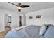 Bedroom featuring a large bed, walk-in closet and pictures on the wall at 2025 E Magdalena Dr, Tempe, AZ 85283