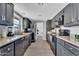Modern kitchen with black cabinets, granite countertops, and stainless steel appliances, great for cooking at 2025 E Magdalena Dr, Tempe, AZ 85283
