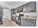 Contemporary kitchen featuring black cabinets, granite countertops, and stainless steel appliances for cooking at 2025 E Magdalena Dr, Tempe, AZ 85283