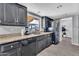 Well-appointed kitchen with black cabinets, granite countertops, and modern appliances, perfect for cooking at 2025 E Magdalena Dr, Tempe, AZ 85283