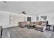 Comfortable living room features a large gray sectional, ceiling fan, and shuttered windows for natural light at 2025 E Magdalena Dr, Tempe, AZ 85283