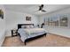 Bright main bedroom with a ceiling fan, plantation shutters, and a comfortable bed at 2025 E Magdalena Dr, Tempe, AZ 85283