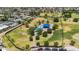 Aerial view of a beautiful community park featuring mature trees, open green spaces, and a playground at 2025 E Magdalena Dr, Tempe, AZ 85283