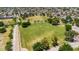 Lush green community park features a walking path and open spaces, with a playground area nearby at 2025 E Magdalena Dr, Tempe, AZ 85283