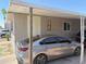 Carport featuring a gray sedan parked in a well maintained mobile home community at 2060 N Center St # 282, Mesa, AZ 85201