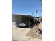 Carport featuring a gray sedan in a well maintained mobile home community at 2060 N Center St # 282, Mesa, AZ 85201