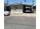 Modest single-story home featuring a covered carport and mature trees in a desert landscape at 2060 N Center St # 282, Mesa, AZ 85201