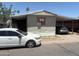 Modest single-story home featuring a covered carport and mature trees in a desert landscape at 2060 N Center St # 282, Mesa, AZ 85201