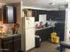 Functional kitchen with dark cabinets and appliances, ready for updates at 2060 N Center St # 282, Mesa, AZ 85201