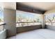 A spacious covered balcony with stone columns and black metal railing overlooks desert landscaping at 21320 N 56Th St # 1158, Phoenix, AZ 85054