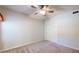 Cozy bedroom with neutral carpet, ceiling fan, and sliding closet doors at 21320 N 56Th St # 1158, Phoenix, AZ 85054