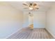 Bedroom featuring neutral carpet, a ceiling fan, and access to a hallway at 21320 N 56Th St # 1158, Phoenix, AZ 85054