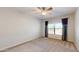 Bright bedroom with a ceiling fan, neutral carpet, and a window offering scenic views at 21320 N 56Th St # 1158, Phoenix, AZ 85054