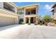Building exterior displaying garages, stone pillars, and balcony at 21320 N 56Th St # 1158, Phoenix, AZ 85054