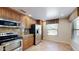 Well-lit kitchen featuring stainless steel appliances, granite countertops, and tile flooring at 21320 N 56Th St # 1158, Phoenix, AZ 85054