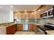 Well-equipped kitchen featuring stainless steel appliances, wood cabinetry, and granite countertops at 21320 N 56Th St # 1158, Phoenix, AZ 85054