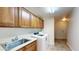 Well-lit laundry room features cabinets, sink, and washer near hall door at 21320 N 56Th St # 1158, Phoenix, AZ 85054