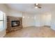 Comfortable living room with a stone fireplace and neutral decor; ceiling fan, tile floor and ample light at 21320 N 56Th St # 1158, Phoenix, AZ 85054