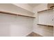 Organized walk-in closet with built-in shelving and wooden hanging rods at 21320 N 56Th St # 1158, Phoenix, AZ 85054