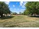 Expansive backyard with manicured lawn, mature trees, and a charming shed at 23265 S Via Del Arroyo --, Queen Creek, AZ 85142