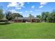 Large backyard featuring lush greenery, a covered patio, and ample space at 23265 S Via Del Arroyo --, Queen Creek, AZ 85142