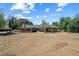 Back exterior showcasing a large brick house with a well-maintained backyard at 23265 S Via Del Arroyo --, Queen Creek, AZ 85142