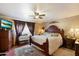 Comfortable main bedroom with hardwood floors and large window at 23265 S Via Del Arroyo --, Queen Creek, AZ 85142