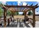 Inviting outdoor patio area with comfortable seating, shaded by a rustic wooden pergola and with a beautiful view at 23265 S Via Del Arroyo --, Queen Creek, AZ 85142