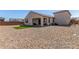 Spacious backyard featuring a covered patio, low-maintenance gravel, and a small section of artificial turf at 25601 N 140Th Ln, Surprise, AZ 85387