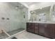 Modern bathroom featuring a glass-enclosed shower and double sink vanity at 25601 N 140Th Ln, Surprise, AZ 85387