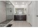 Bright bathroom with marble-tiled shower, dual sink vanity, and neutral tones at 25601 N 140Th Ln, Surprise, AZ 85387