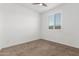 Neutral bedroom with carpeted floors, ceiling fan, and window with shutters at 25601 N 140Th Ln, Surprise, AZ 85387