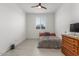 Bedroom with light floors, window with shutters, and ceiling fan at 25601 N 140Th Ln, Surprise, AZ 85387
