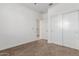 Simple bedroom with carpet, white walls, closet, and a door to hallway at 25601 N 140Th Ln, Surprise, AZ 85387