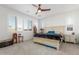 Serene main bedroom featuring plantation shutters, a ceiling fan, and a neutral color palette for a relaxing atmosphere at 25601 N 140Th Ln, Surprise, AZ 85387